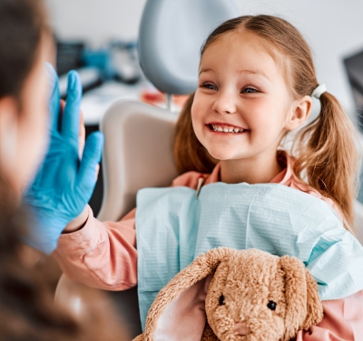 A child smiling after pediatric dentistry in kansas city