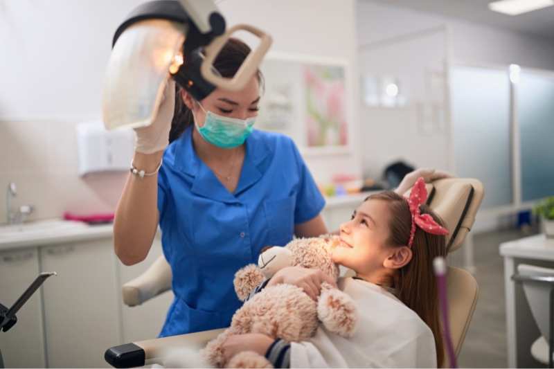 Child smiling during a visit at Staley Dental Arts, a family dentist serving as a pediatric dentist near me.