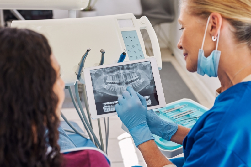 Dentist explaining walk in treatment options to a patient at Staley Dental Arts.